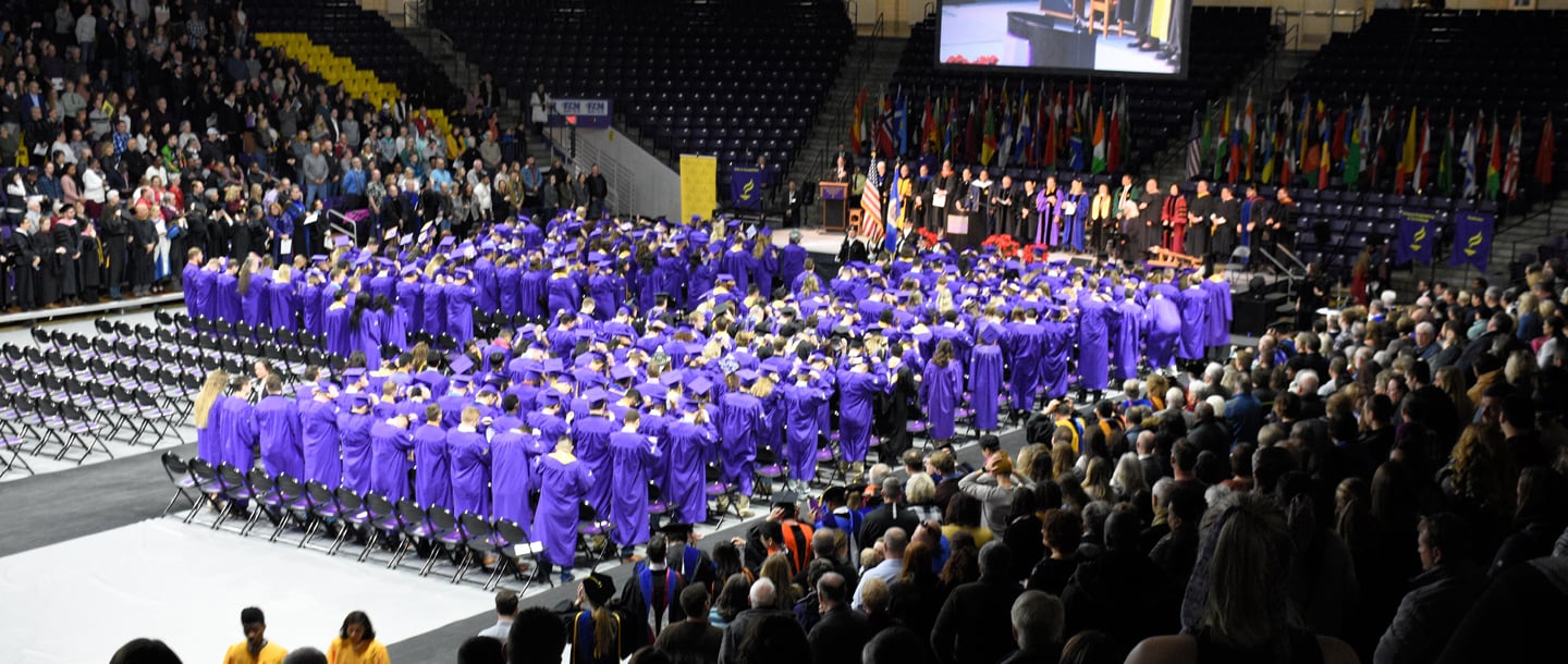 Graduates standing during the commencement ceremony 