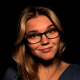 a person wearing glasses and smiling