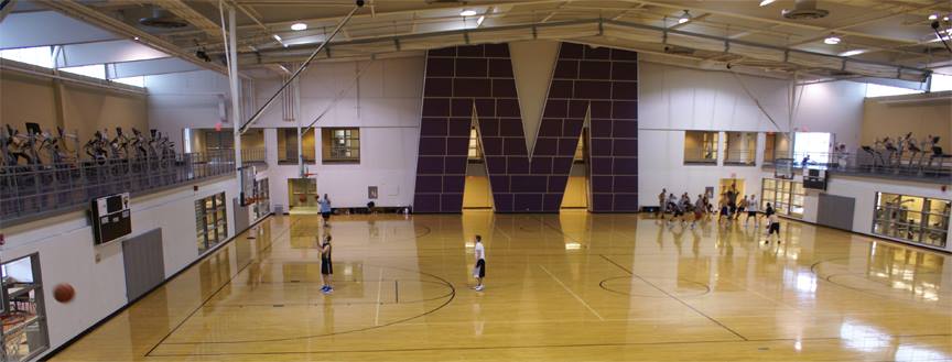a group of people playing basketball in a gym