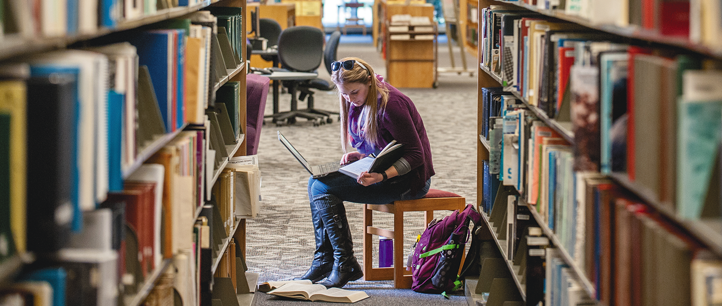 Student reading in the library