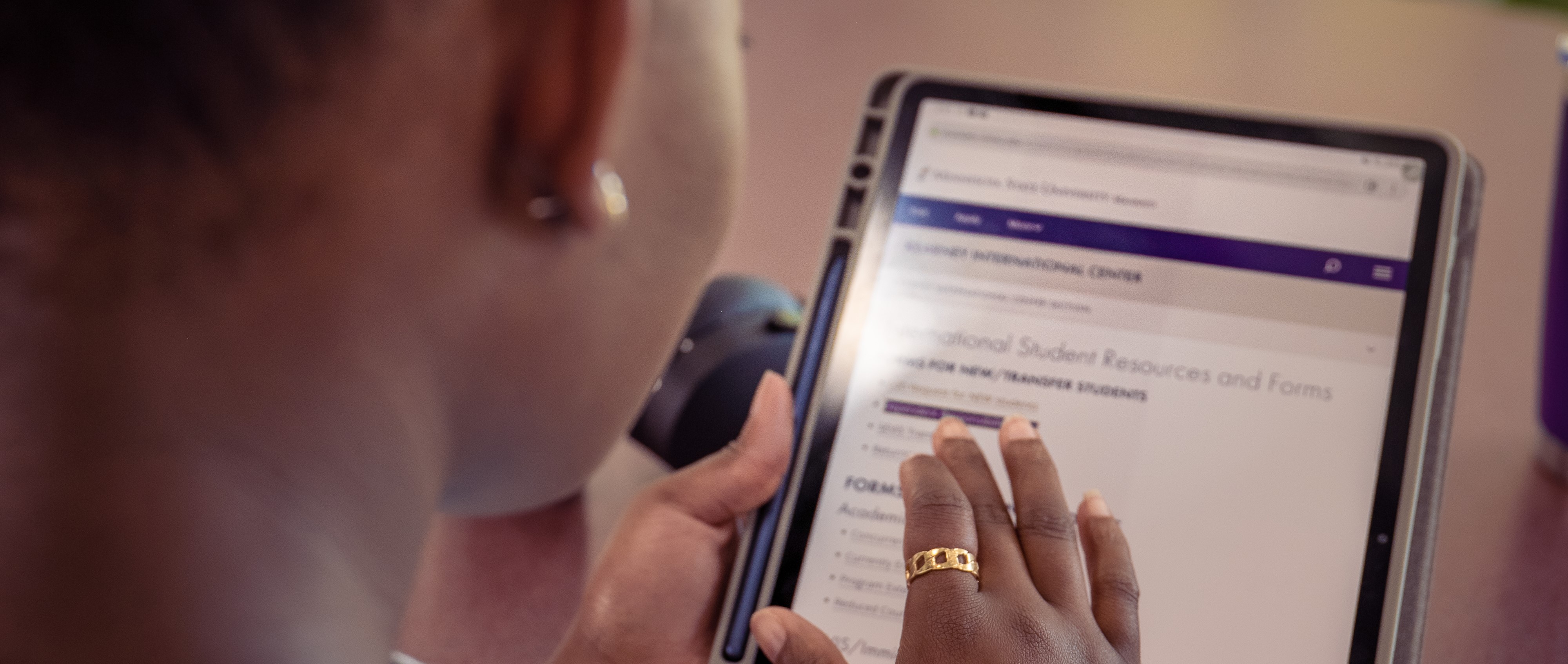 Close-up of a student's hands using a tablet