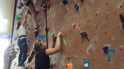 Junior high students climbing the rock wall