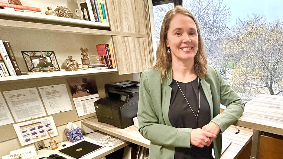 Kristin Scott, Marketing professor at Minnesota State University, posing in her office with a smile