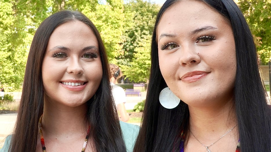 Ayasha and Winona WIlliams posing outside on campus with smiles