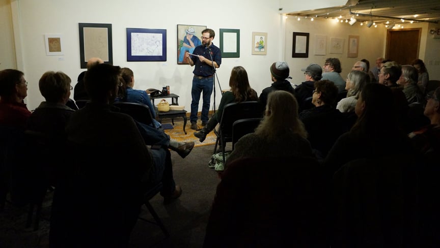 A crowd of people listening to a person tell a story