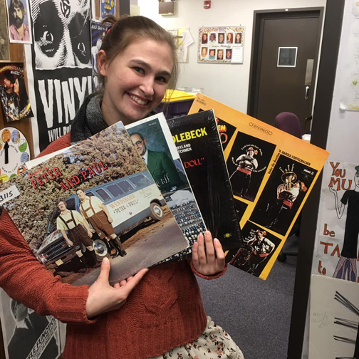 Katie Jo Findley holding several old Polka records