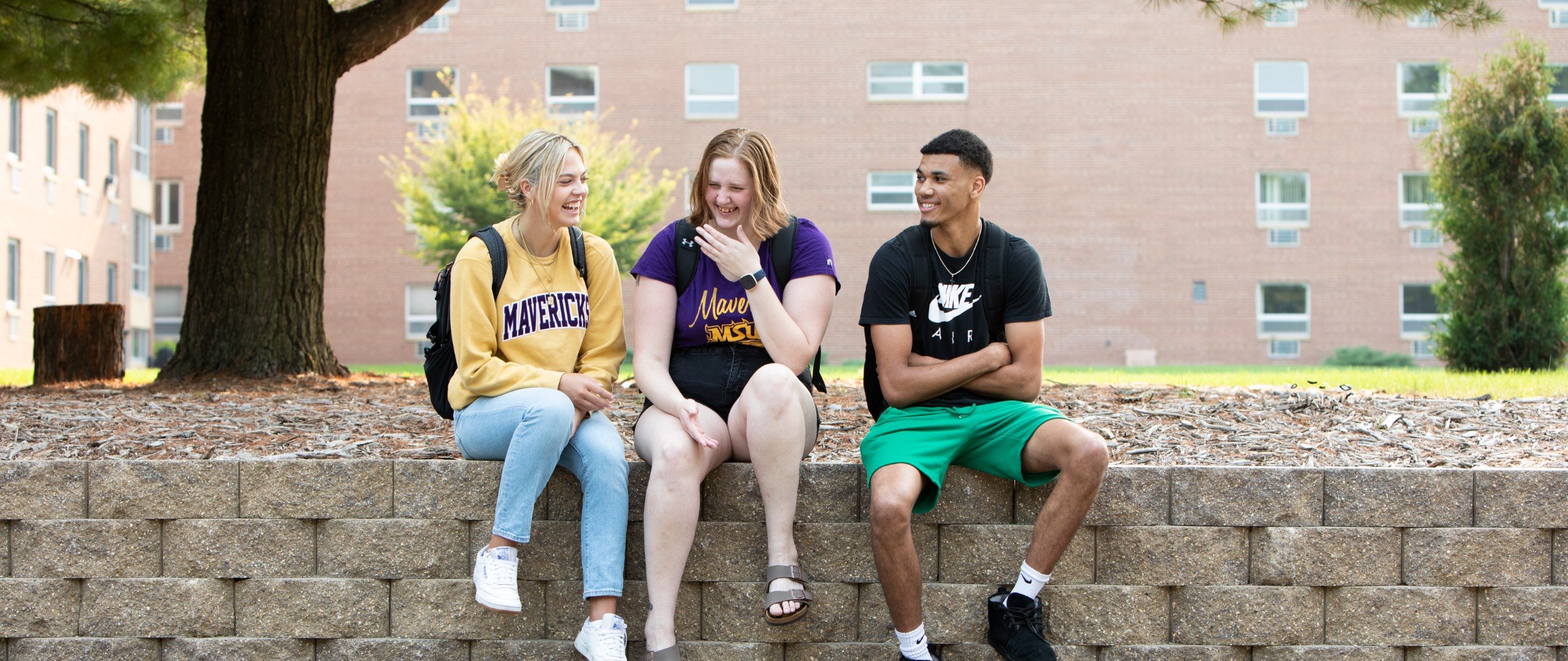 a group of people sitting on a wall