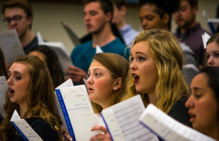 a group of people singing in a choir